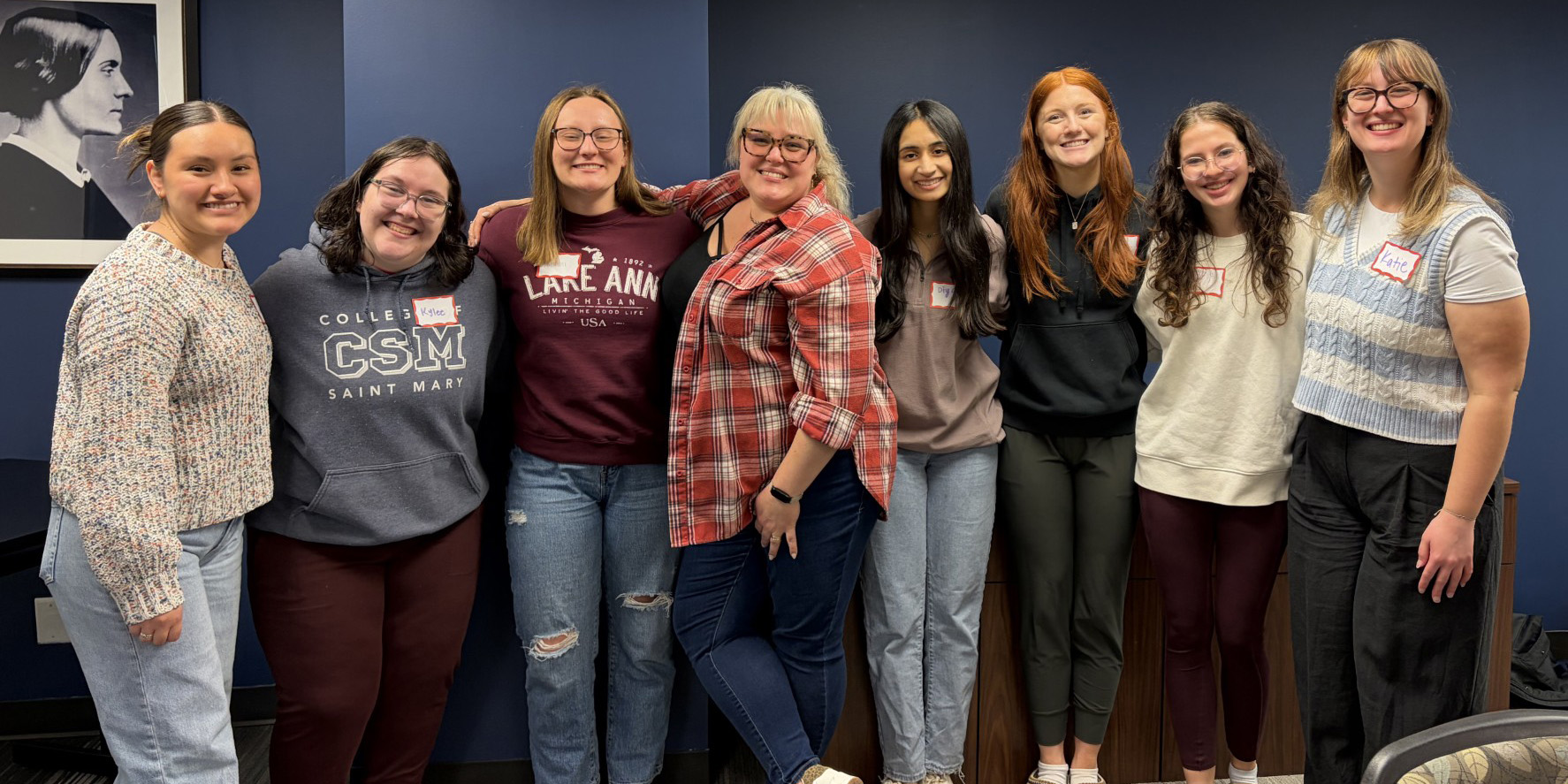 A group of College of Saint Mary students stand together.